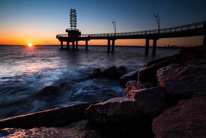 A pier overlooking a body of water at sunset