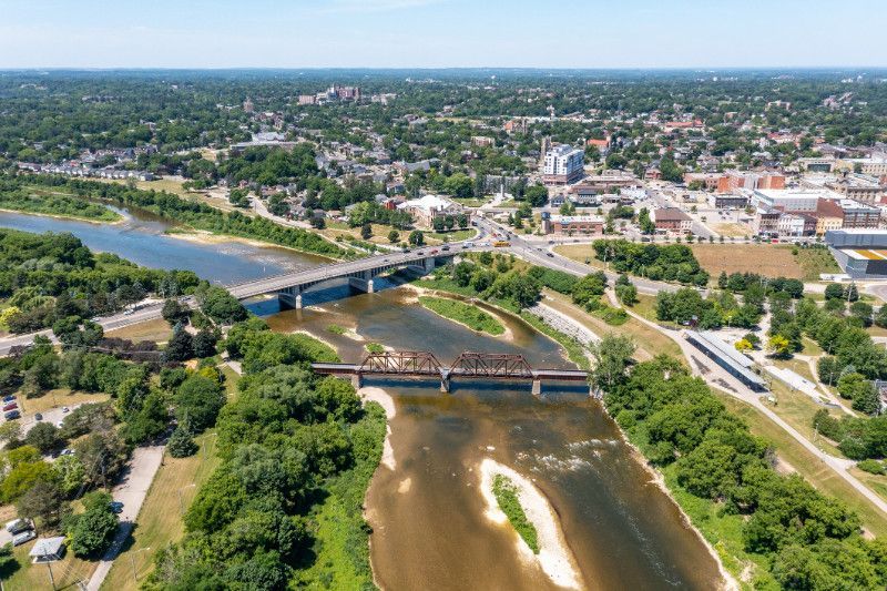 An aerial view of a bridge over a river in a city.
