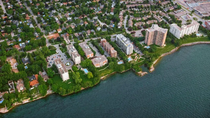 An aerial view of a city along the shore of a lake.
