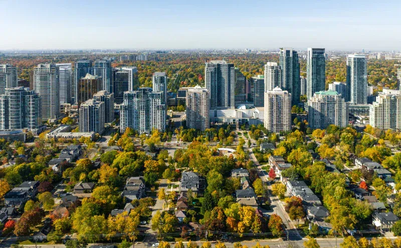 An aerial view of a city surrounded by trees and buildings.