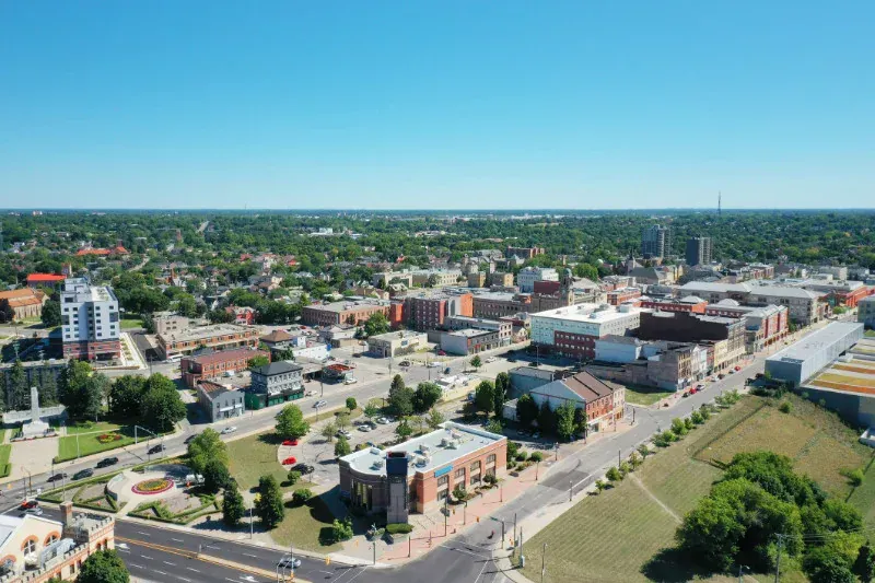 An aerial view of a city with lots of buildings and trees.
