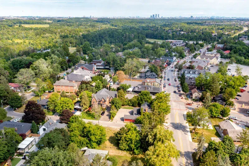 An aerial view of a residential area with lots of trees and houses.
