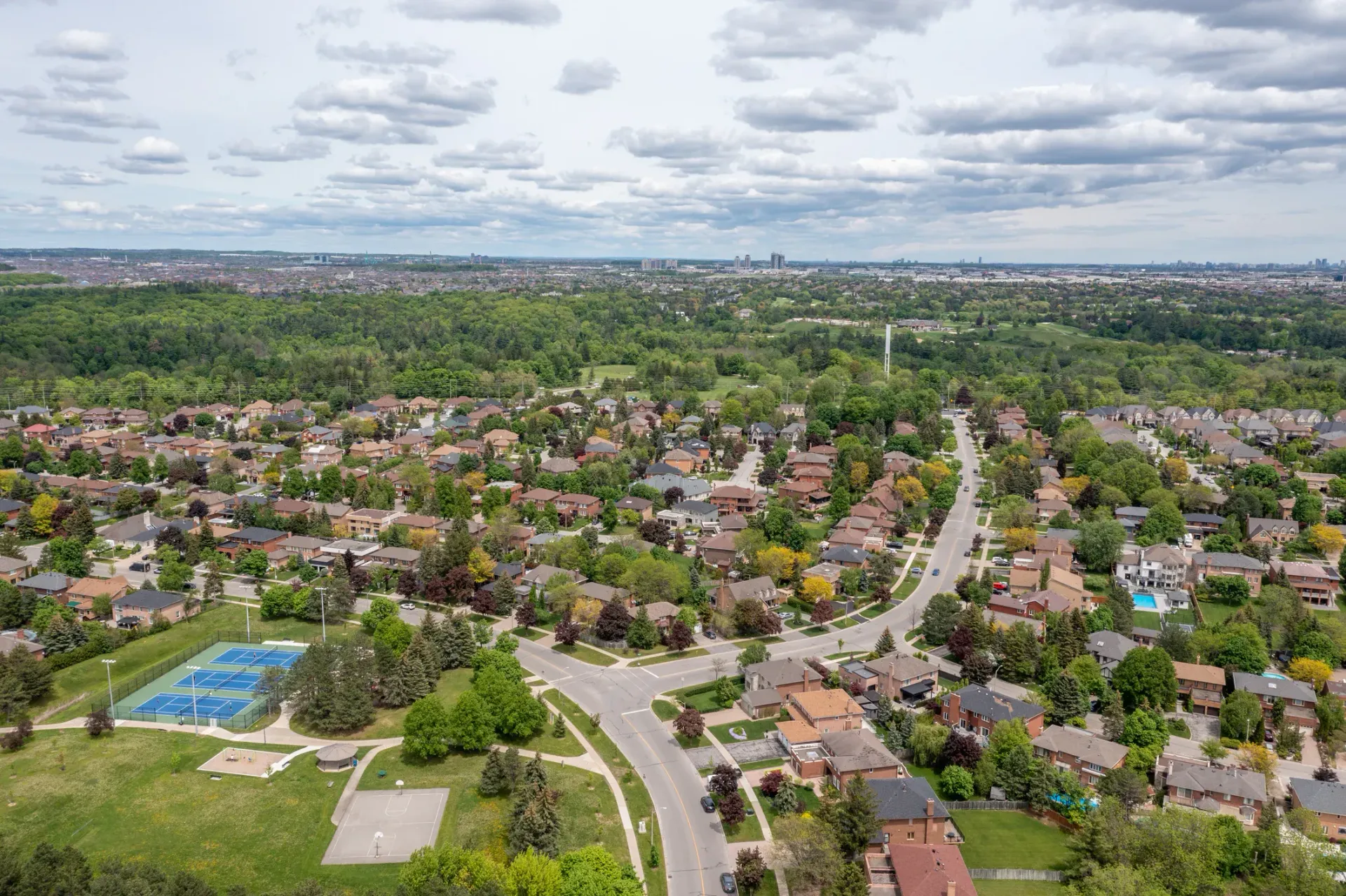 An aerial view of a residential area with lots of trees and houses.