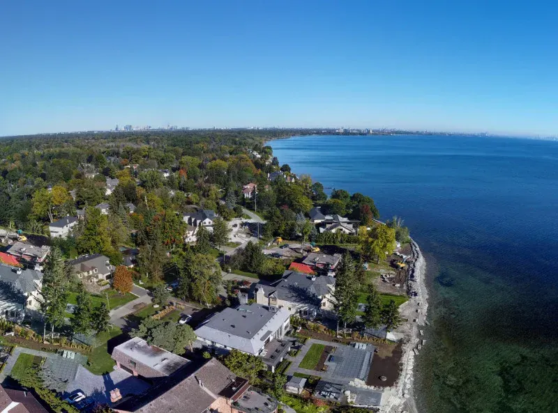 An aerial view of a residential area next to a body of water
