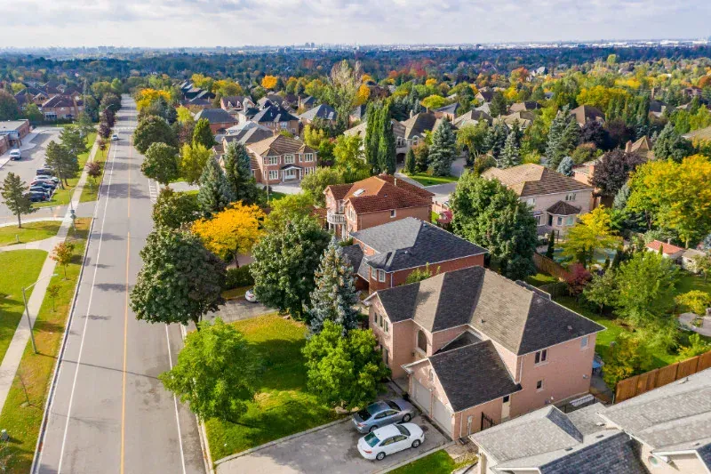 An aerial view of a residential area with lots of houses and trees.
