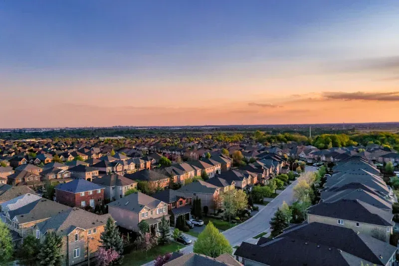An aerial view of a residential neighborhood at sunset.