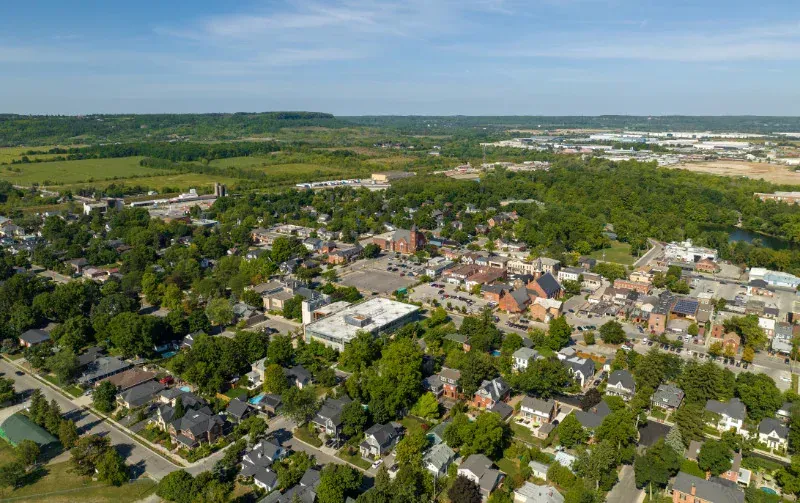 An aerial view of a small town surrounded by trees.