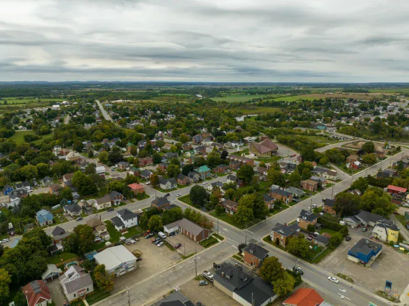 An aerial view of a small town with lots of houses and trees.