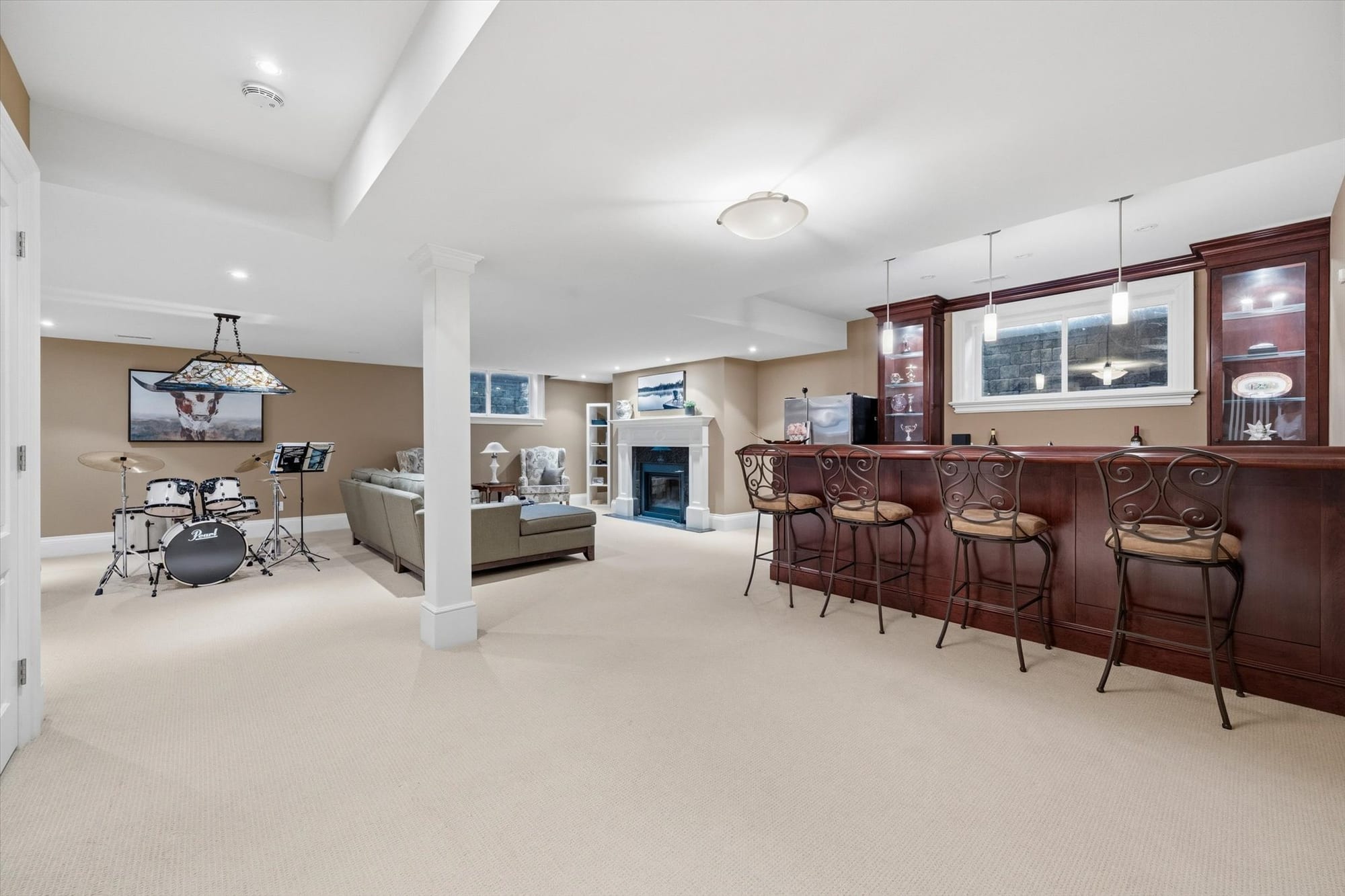 Finished lower level with a wet bar, fireplace and lounge in a luxury Oakville home, sold by the Dan Cooper Group.