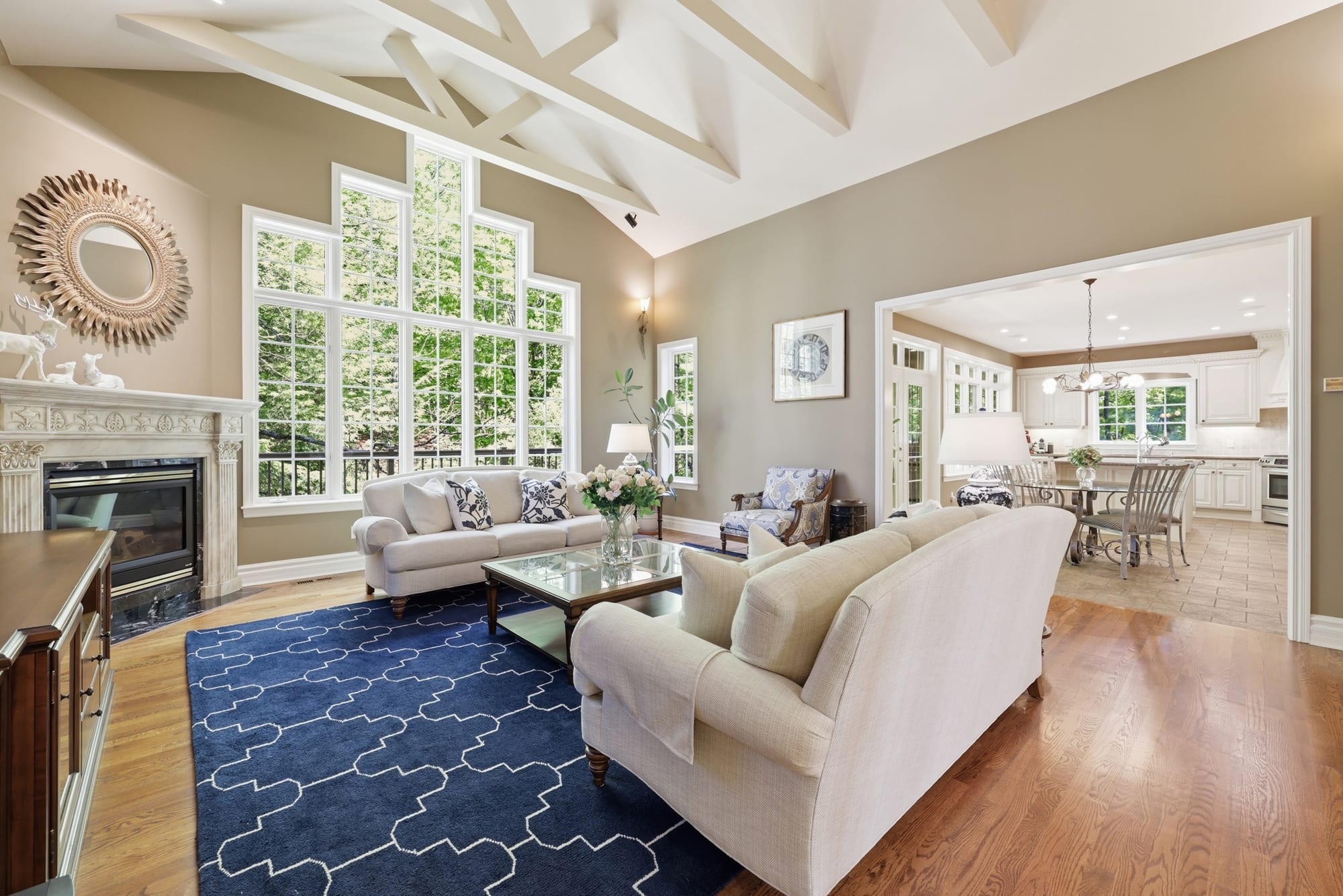 Vaulted great room with fireplace and tall windows in a luxury Oakville residence, marketed by the Dan Cooper Group.