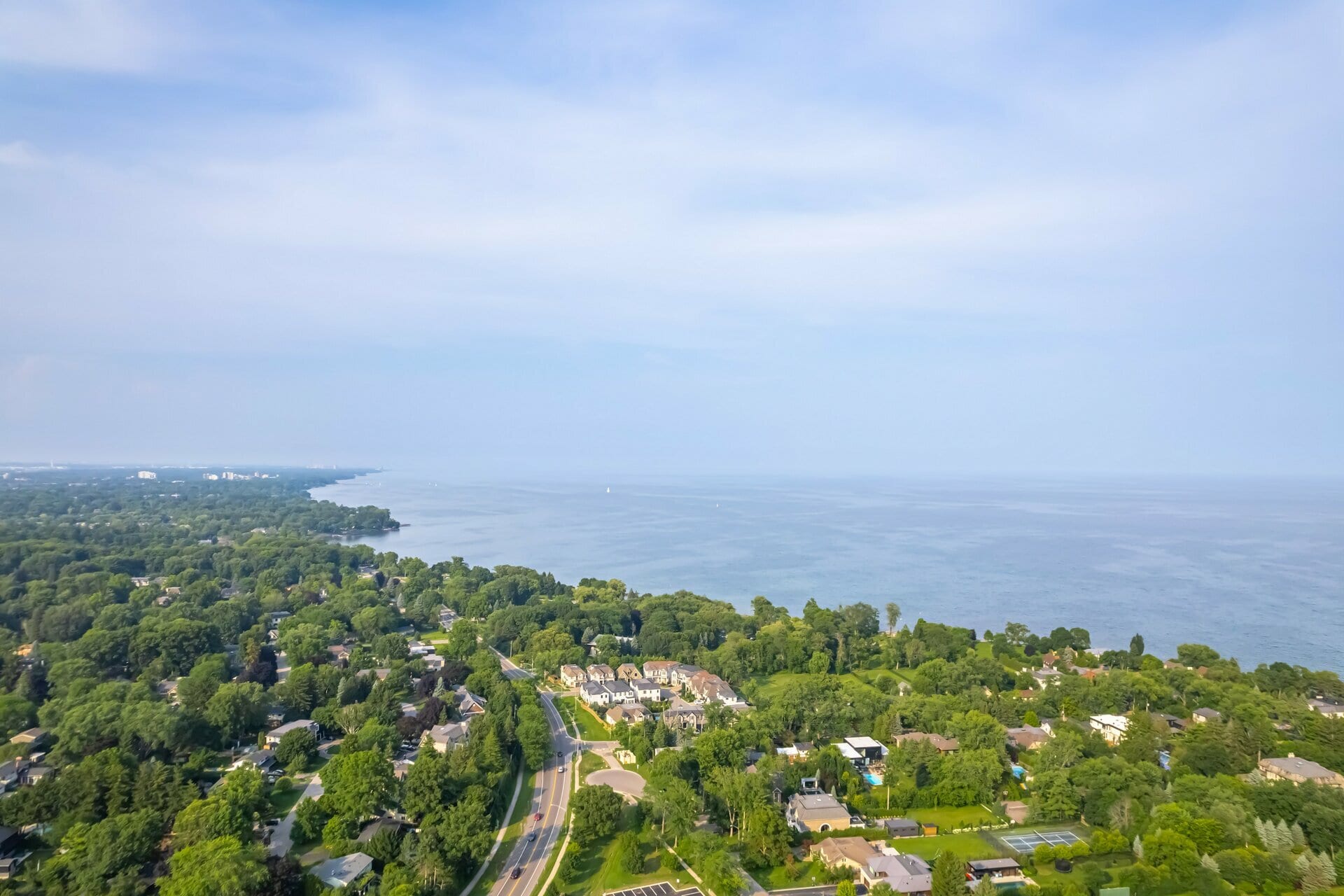 Aerial view of a tree-lined lakeshore neighbourhood along Lake Ontario.