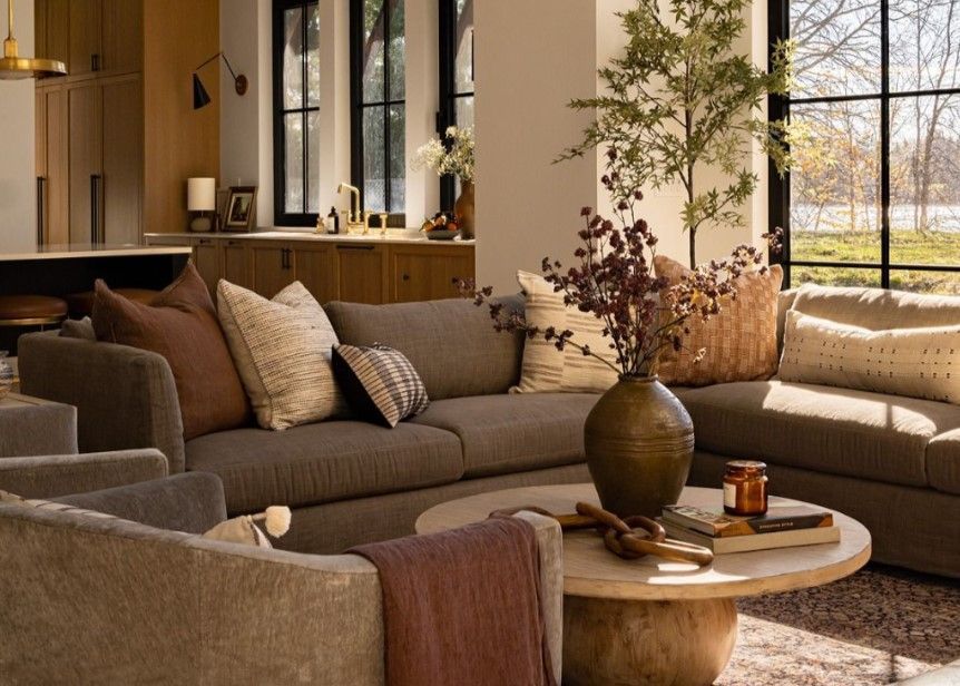 Bright living room with neutral tones and large windows.